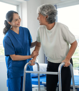 Nurse helping her patient with her walker.