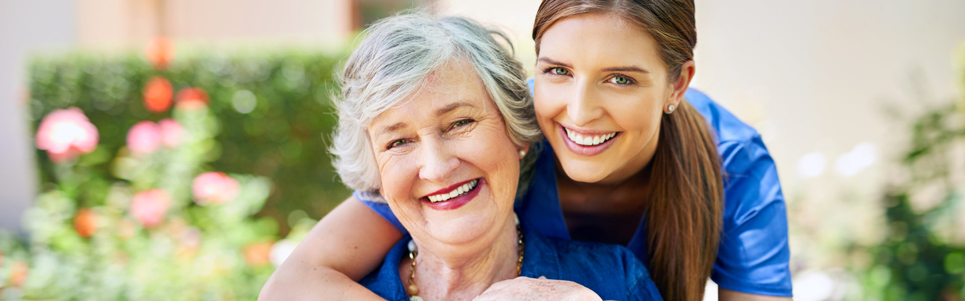 Two persons smiling.