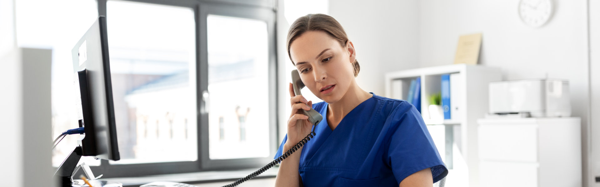 Nurse calling using telephone.