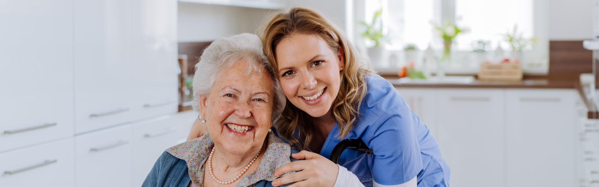 Two persons smiling.