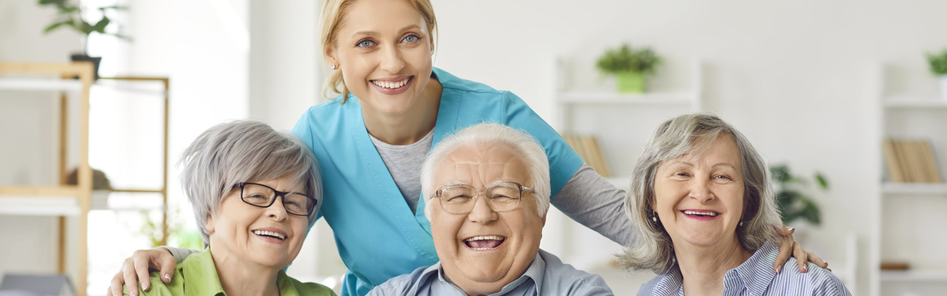 Nurse with three elderly smiling.