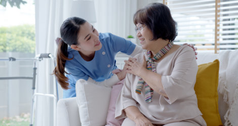 Nurse assisting woman.